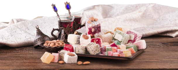 Arabic traditional sweets and berry with tea on plate