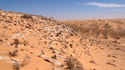 Fototapeta na wymiar Rocky slope on a hill in the Sahara Desert, outside of Douz, Tunisia