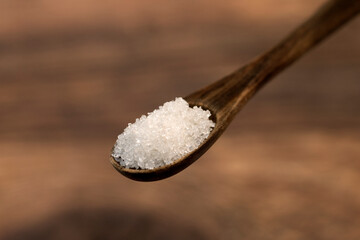 spoonful of sugar in a wooden teaspoon 