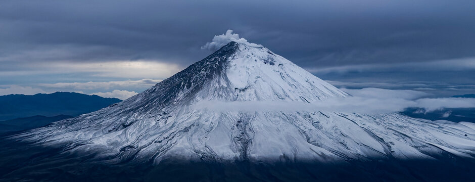 Mount Chimborazo in Ecuador during a flyby, showihg smoke from the top. The volcano erupted only 2 hours after this shot..