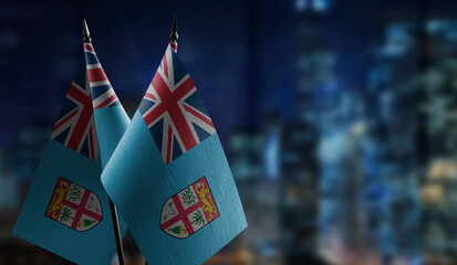 Small flags of the Fiji on an abstract blurry background