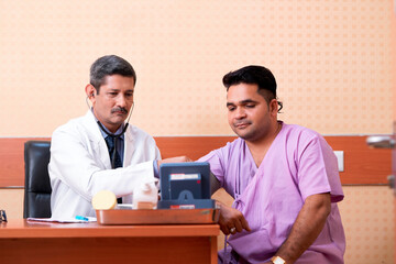 Doctor check up to young patient blood pressure at clinic.