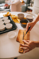 Crème brûlée ingredients and preparation. Cutting of fresh vanilla.