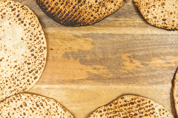 Matzah Shmurah for Jewish holiday Pesach laid out in the frame on wooden background.