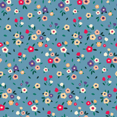 Seamless floral pattern, liberty ditsy print with cute mini flowers. Pretty botanical design for fabric, paper: small hand drawn flowers, tiny leaves on a blue background. Vector illustration.