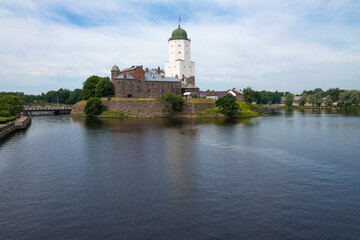 Fototapeta premium View of the ancient Vyborg castle from the Northern harbor on a July morning. Vyborg. Leningrad region, Russia