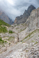 Fototapeta na wymiar Hikers on a trail in a mountainous barren landscape