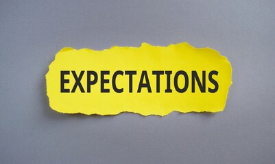 inscription Expectations word on yellow torn papper