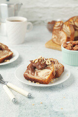A piece of marble biscuit with chocolate cream and nuts