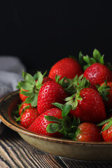 A bowl with ripe bright strawberry in rustic style