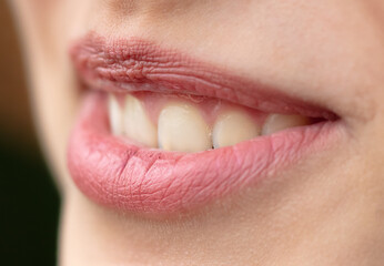 Lips of a young smiling girl as a background.