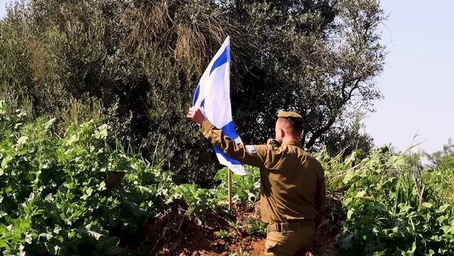 Israeli soldier kisses the Israel Flag twice and salutes the Flag. Video concept: IDF, Memorial Day, Holocaust Remembrance Day, soldiers Israel, patriotism