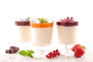 appetizing glass of panna cotta with berry sauce
