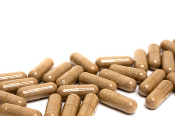 Capsules. Herb capsule, Nutritional Supplement, Vitamin Pill, Herbal Medicine on white background. Copy Space
