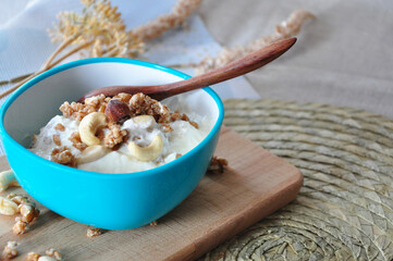 Bowl of Yogurt Granola on Wooden Board with Copy space