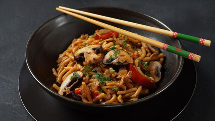 Chinese stir fried Instant noodles with mushrooms and chopsticks