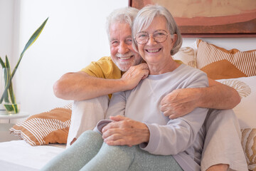 Love lives forever! Senior couple portrait at home. Handsome old man and attractive old woman are...