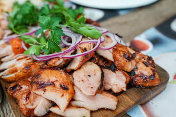 A plate with barbecue shish kebab of different types of meat and red onion rings