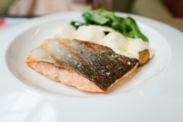 Grilled salmon on a plate in a restaurant