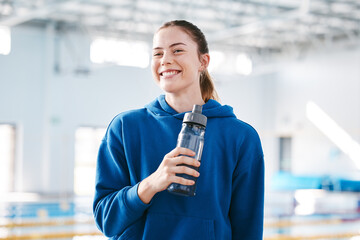 Swimmer, sports of happy woman drinking water to relax after exercise, workout or training on break. Hydrate, athlete fitness or girl smiling with happiness, motivation or liquid bottle for hydration