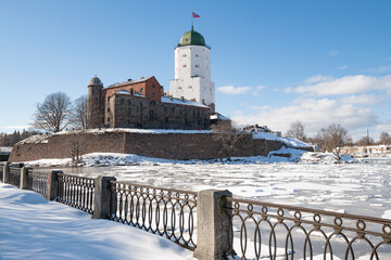 View of the ancient Vyborg castle from the side of the city embankment on a sunny March. Leningrad...