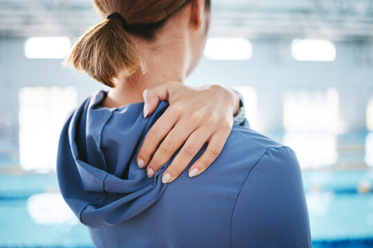 Hands, back pain and injury at swimming pool after exercise, training or workout accident. Sports, swim athlete and woman with ache, fibromyalgia or injured shoulder after exercising or practice