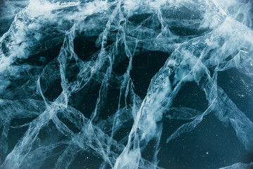 The beautiful Baikal ice with magical cracks before your eyes. This is really cool. The camera moves down the ice. Extreme close-up view.