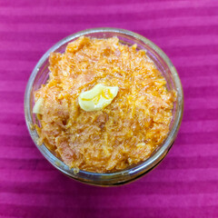 selective focus picture of indian dessert food: carrot halwa or gajar ka halwa