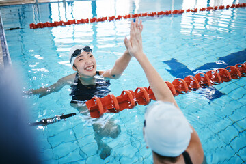 Swimming pool, sports and women high five in water for teamwork, collaboration or solidarity....