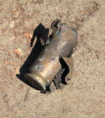 Exploded and burnt cartridge case after shot. Battlefield and the remnants of weapons ammunition...