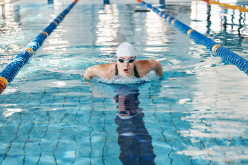 Sports, swimming pool or woman training in water for a race competition, exercise or cardio...