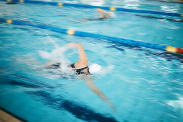 Sports, water splash or women in swimming pool for a race competition, exercise or cardio workout....