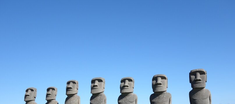 replicate easter island moai statues Ahu Akivi with clear blue sky at sun messe nichinan, miyazaki, japan front view banner