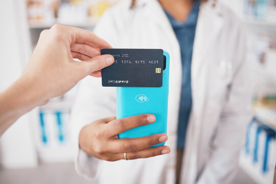 Hands, pharmacy and credit card shopping with phone, payment and fintech for healthcare at store. Woman pharmacist, digital customer experience and ecommerce for medicine product at shop with pos