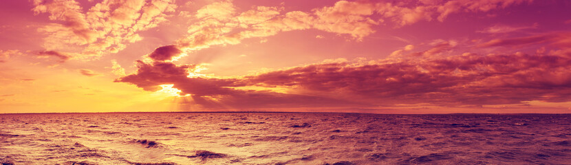 Naklejka na ściany i meble Seascape in the evening. Sunset over the sea with the beautiful blazing sky