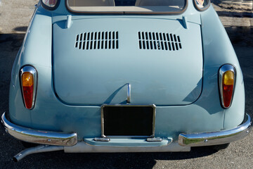 Fototapeta na wymiar Rear of an old german classic car . Particular view of rear lights and shiny chrome bumper