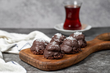 Coconut and chocolate chip cookies..Bakery products. Cookies with tea on dark background