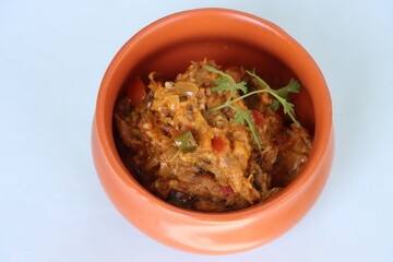Baigan Bharta or Vangyache Bharit, a roasted and mashed eggplant fry or curry, favourite maharashtrian curry, served in a bowl, Indian traditional food