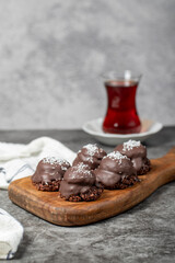 Coconut and chocolate chip cookies..Bakery products. Cookies with tea on dark background