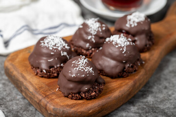 Coconut and chocolate chip cookies..Bakery products. Cookies with tea on dark background. Close up