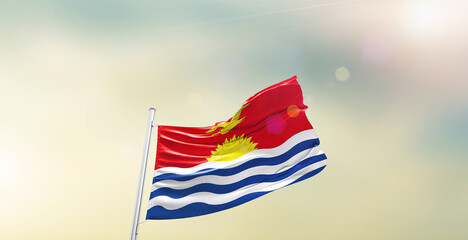Waving Flag of Kiribati on blur sky. The symbol of the state on wavy cotton fabric.