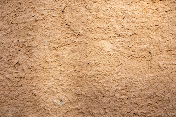 Dry brown mud plaster wall floor background texture. Empty soil ground, blank backdrop. Copy space.