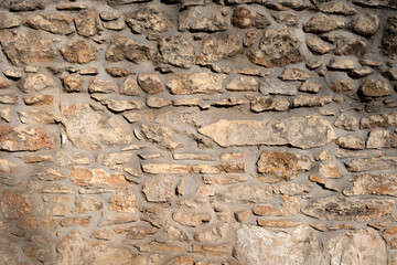 Empty stonewall combination of grey beige gold color stone background texture. Copy space.