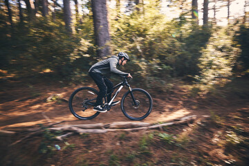 Man, outdoor and cycling in nature for sports, exercise or training on a mountain bike with speed....