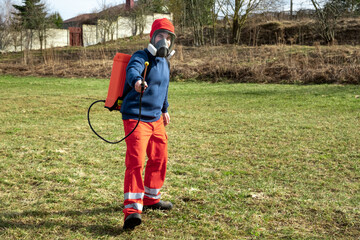 Man gardener wearing protective clothing and full face respirator mask with dust filters and...