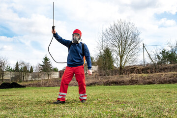 Man gardener wearing protective clothing and full face respirator mask with dust filters and...