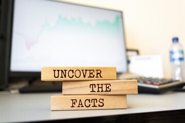 Wooden blocks with words 'Uncover the Facts'. Business concept