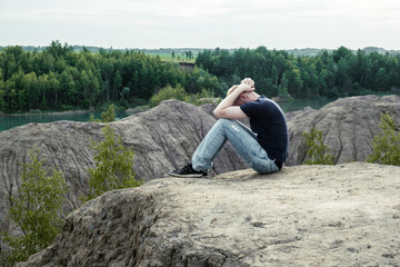 A man surrounded by mountains. Feelings of loneliness, sadness