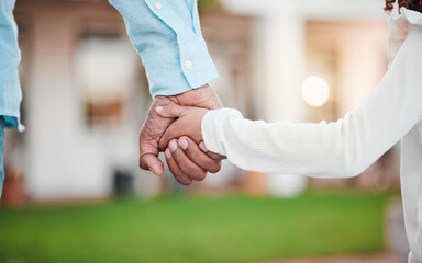 Fototapeta premium Holding hands closeup, parent and kid together in garden with dad love, care or support. Papa, family and child hand in outdoor solidarity, nature and trust with father and young person in affection