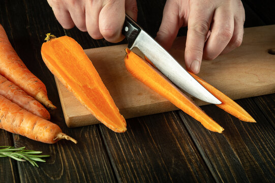 The Cook Cuts Carrots On A Cutting Board For Making Delicious Borscht At Home. Copy Space